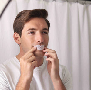 Man applying Dryft mouth tape